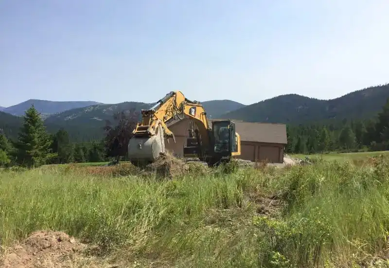 Cleared building site below the Montana mountains