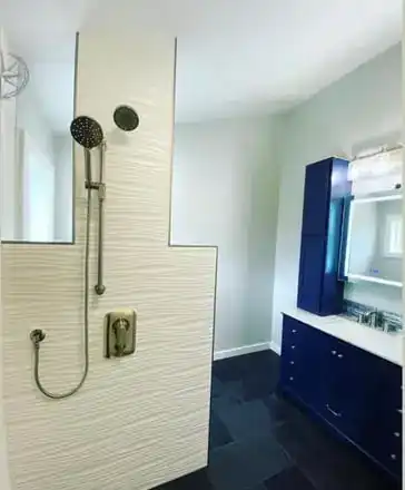 Finished bathroom remodel: tiled walk-in shower and navy vanity, Missoula Homestead