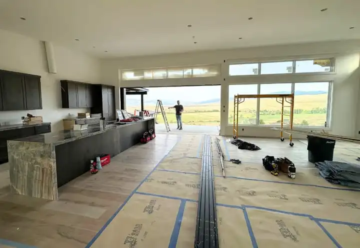 Interior under construction, radiant tubing laid and a glass wall to the valley