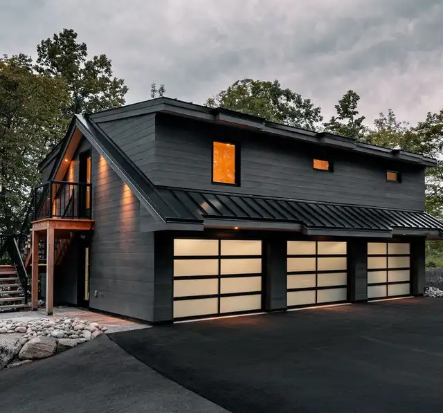 Garage with an upper-storey apartment, dark siding